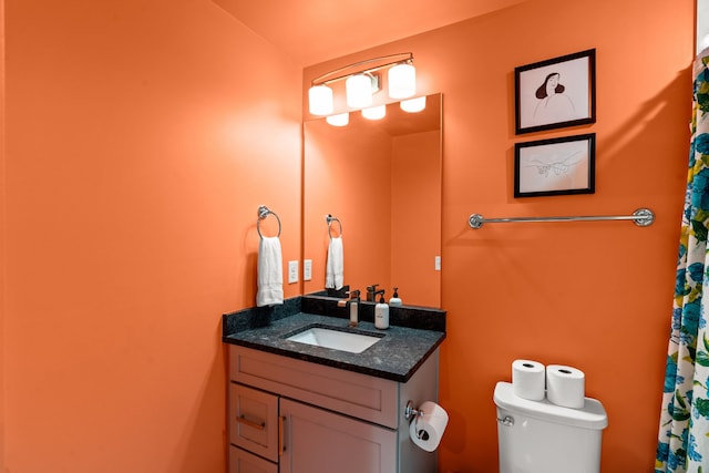 bathroom featuring toilet and vanity