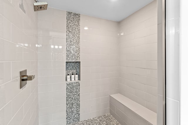 bathroom with a tile shower