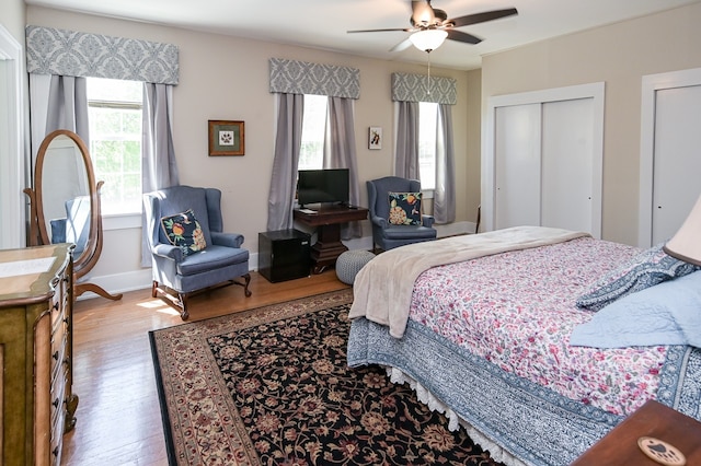 bedroom with light hardwood / wood-style floors and ceiling fan