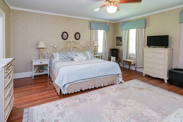 bedroom with ceiling fan, dark hardwood / wood-style floors, and ornamental molding