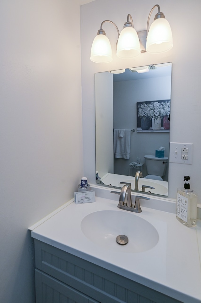 bathroom featuring vanity and toilet