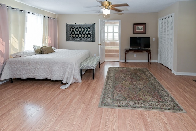 bedroom with connected bathroom, ceiling fan, a closet, and light hardwood / wood-style floors