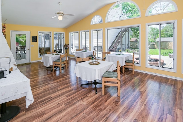 dining space with lofted ceiling, ceiling fan, and dark wood-type flooring