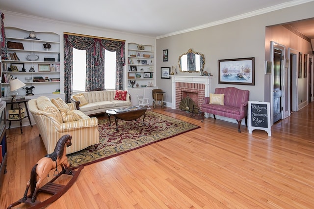 living room with crown molding, light hardwood / wood-style flooring, and a brick fireplace