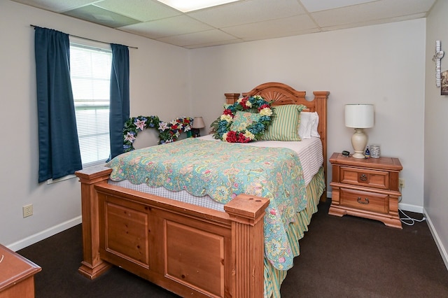 carpeted bedroom with a drop ceiling