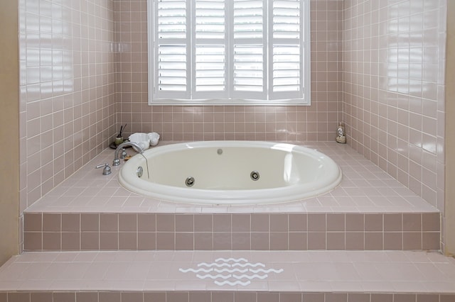 bathroom with a relaxing tiled tub