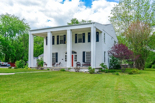 neoclassical / greek revival house featuring covered porch and a front lawn