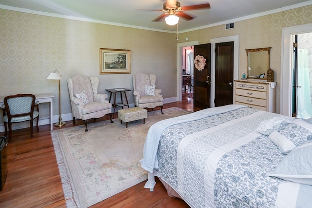 bedroom featuring hardwood / wood-style flooring, ceiling fan, and ornamental molding