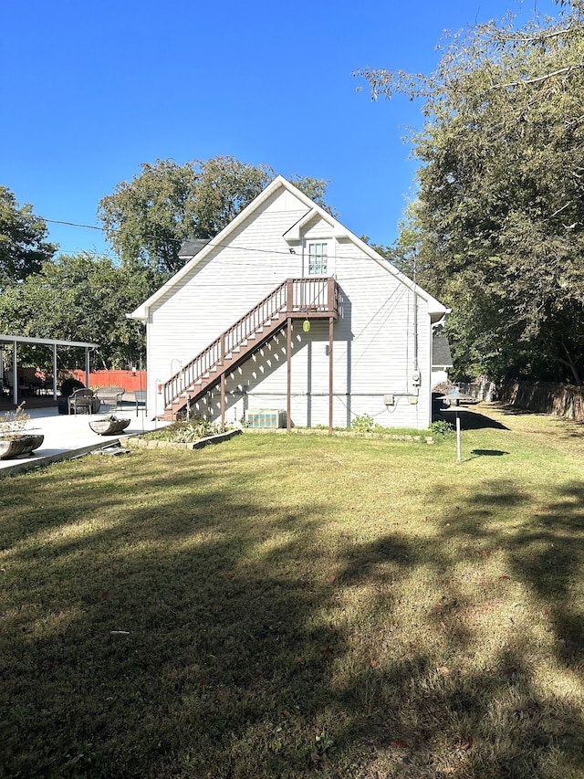 view of side of home featuring a yard