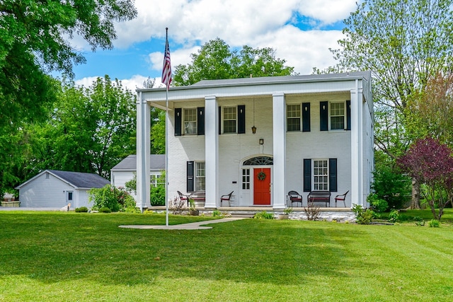 neoclassical / greek revival house featuring covered porch and a front yard