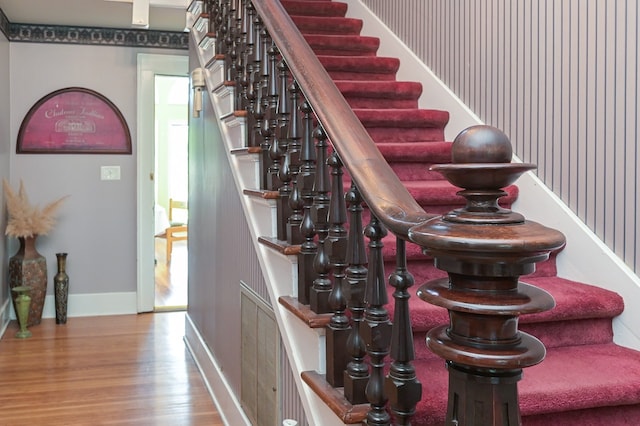 staircase with hardwood / wood-style floors