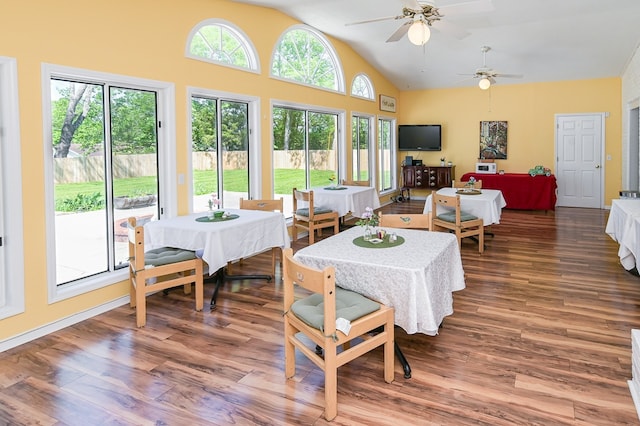 dining area featuring ceiling fan, hardwood / wood-style floors, and lofted ceiling