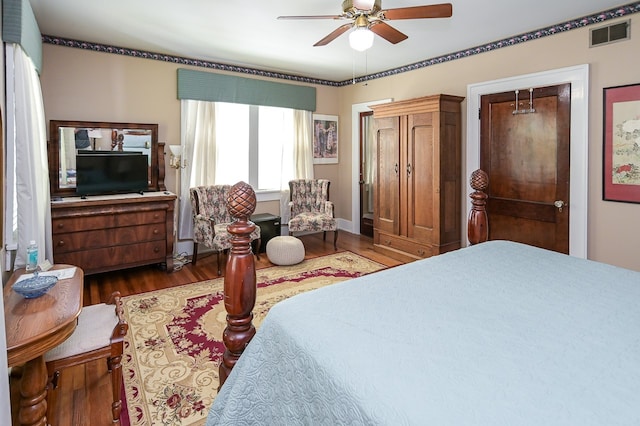 bedroom with ceiling fan, a closet, and dark wood-type flooring