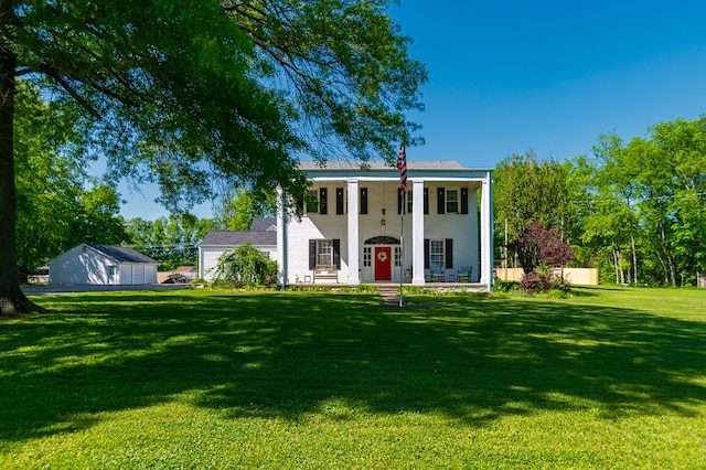 neoclassical home with covered porch and a front yard