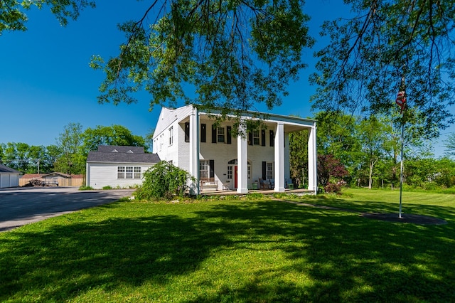 view of front of home featuring covered porch and a front yard