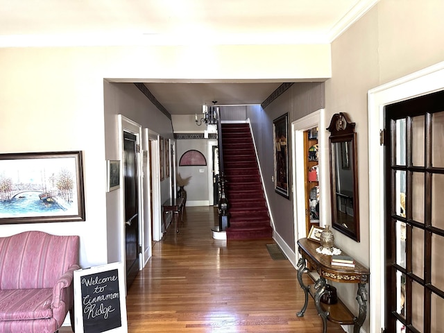 hall with dark wood-type flooring and a chandelier