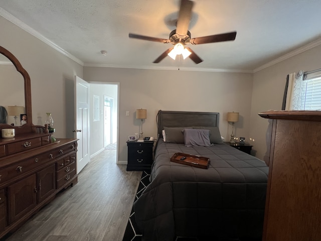 bedroom featuring ceiling fan, ornamental molding, and light hardwood / wood-style floors