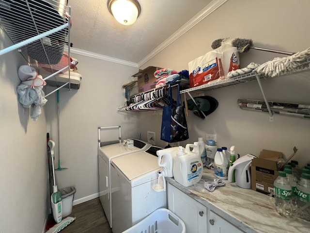 laundry area with cabinets, washing machine and dryer, dark hardwood / wood-style floors, and ornamental molding