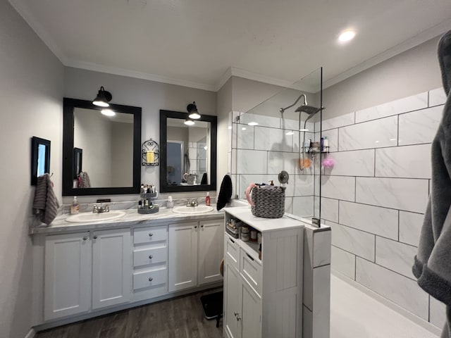 bathroom with vanity, a shower, crown molding, and wood-type flooring