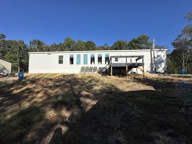 rear view of house with a wooden deck