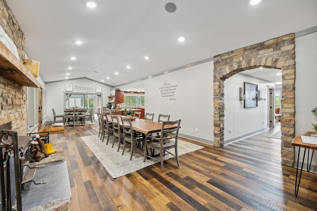 dining room featuring hardwood / wood-style flooring and vaulted ceiling