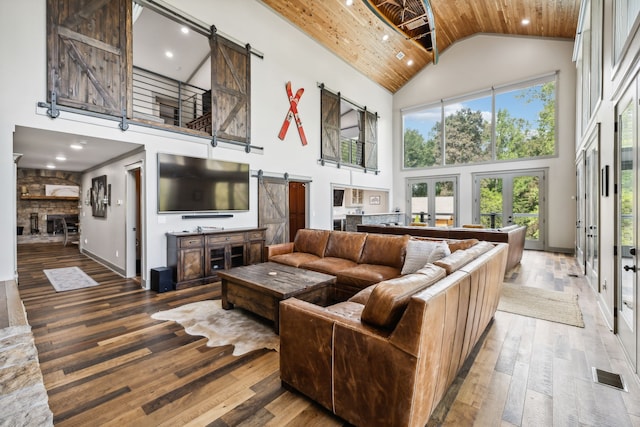 living room with wooden ceiling, wood-type flooring, french doors, and high vaulted ceiling