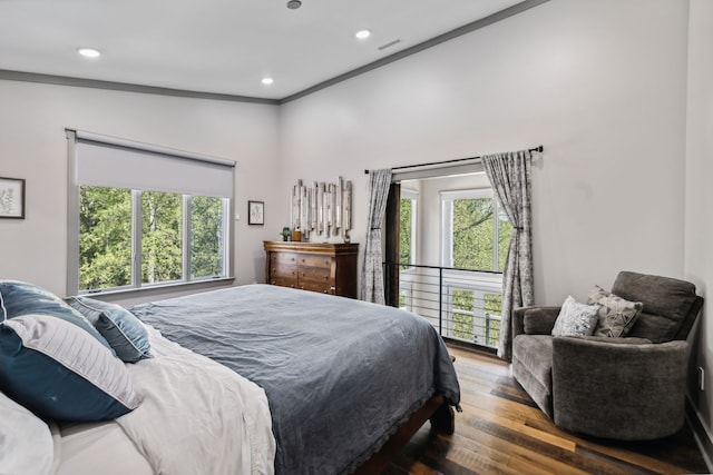 bedroom with ornamental molding, lofted ceiling, and dark wood-type flooring