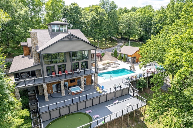 1657 Boswell Rd, Winchester, TN 37398 - back of property with stone siding, a putting green, a patio area, a balcony, and a jacuzzi