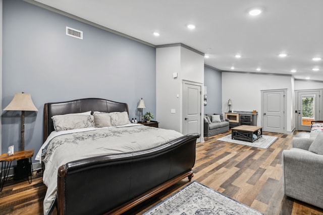 bedroom with crown molding and hardwood / wood-style flooring