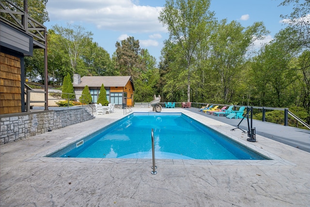 view of swimming pool featuring a patio area