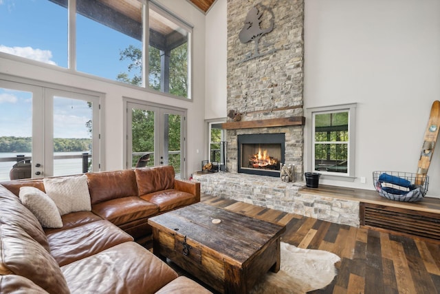 1657 Boswell Rd, Winchester, TN 37398 - living room with a towering ceiling, french doors, hardwood / wood-style floors, a stone fireplace, and healthy amount of natural light