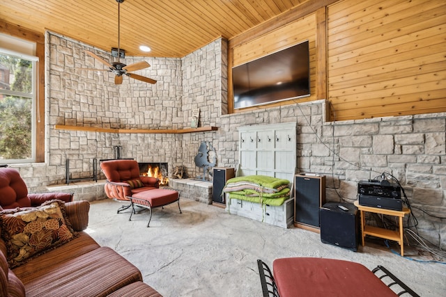 living room featuring a fireplace, wood ceiling, concrete flooring, and ceiling fan