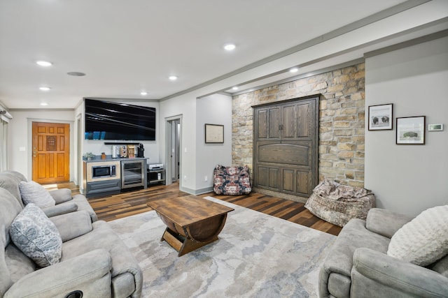 living room with ornamental molding and dark hardwood / wood-style flooring