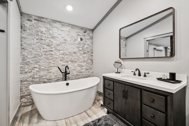 bathroom featuring vanity, a bathing tub, and hardwood / wood-style floors