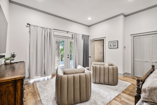 bedroom featuring crown molding, a closet, french doors, and light hardwood / wood-style floors