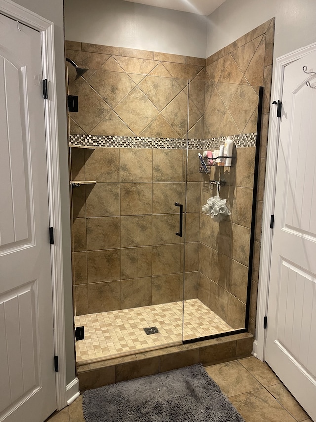 bathroom with walk in shower and tile patterned floors