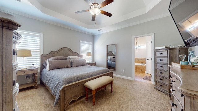 bedroom with ensuite bathroom, ceiling fan, a tray ceiling, crown molding, and light carpet