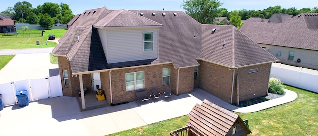 back of property featuring a patio and a yard