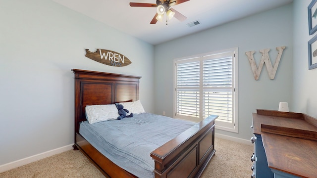 carpeted bedroom with ceiling fan and multiple windows