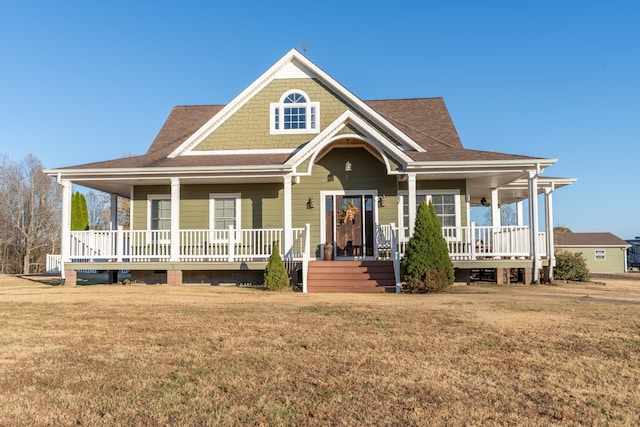 view of front of property featuring covered porch and a front yard