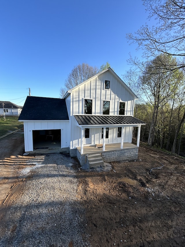 modern farmhouse style home featuring a garage and a porch