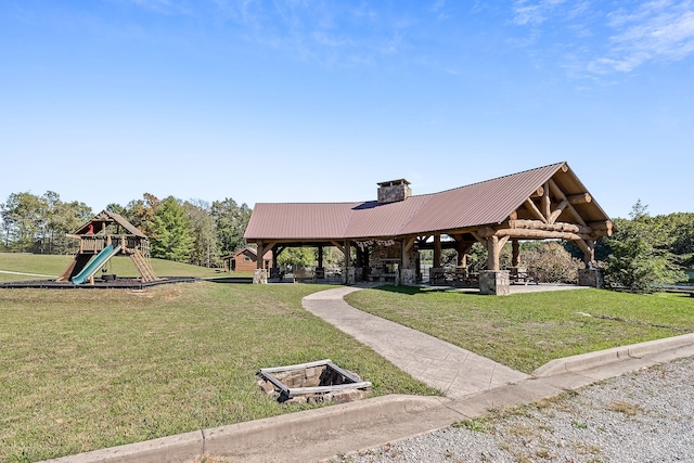 view of property's community featuring a playground, a gazebo, and a lawn