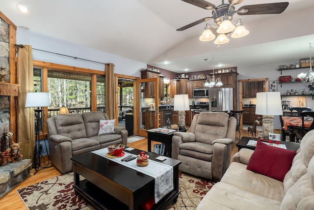 living room with ceiling fan, light hardwood / wood-style flooring, and vaulted ceiling