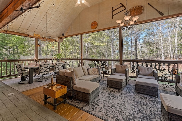 sunroom featuring ceiling fan with notable chandelier, lofted ceiling, and wood ceiling