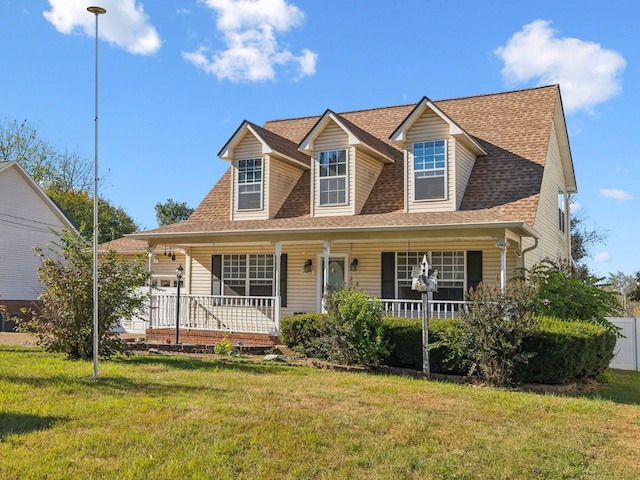 cape cod house featuring a front lawn and covered porch