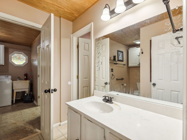 bathroom with washer / clothes dryer, wood ceiling, toilet, tile patterned floors, and vanity