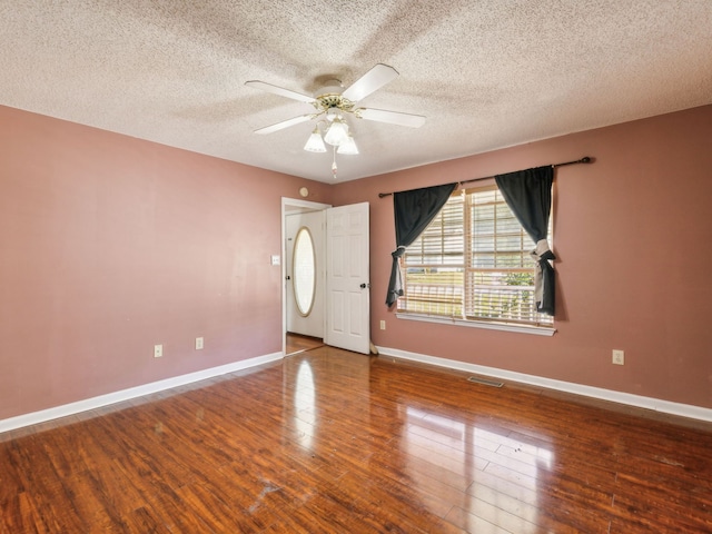 entrance foyer with ceiling fan, a textured ceiling, and hardwood / wood-style floors