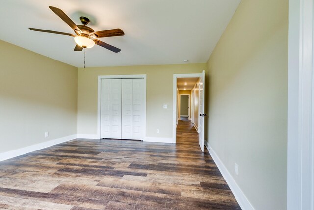 10890 Minor Hill Hwy, Goodspring, TN 38460 - unfurnished bedroom with dark wood-type flooring, a closet, baseboards, and a ceiling fan