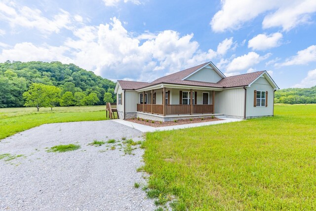 10890 Minor Hill Hwy, Goodspring, TN 38460 - view of front facade featuring covered porch, gravel driveway, and a front yard