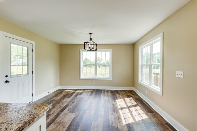 10890 Minor Hill Hwy, Goodspring, TN 38460 - unfurnished dining area featuring healthy amount of natural light, a chandelier, and dark wood finished floors